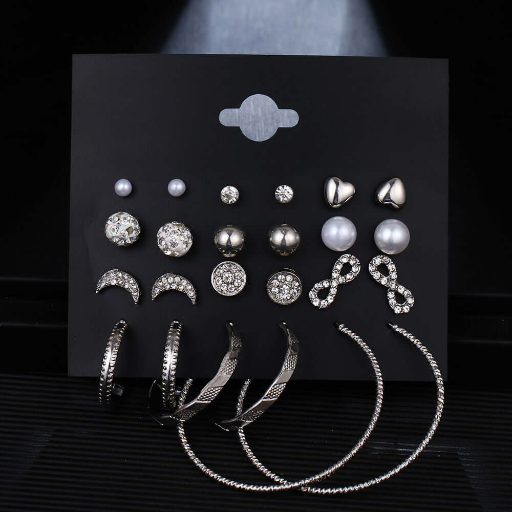 12 pairs of star and moon diamond earrings set featuring silver designs with intricate geometric shapes and sparkling accents.