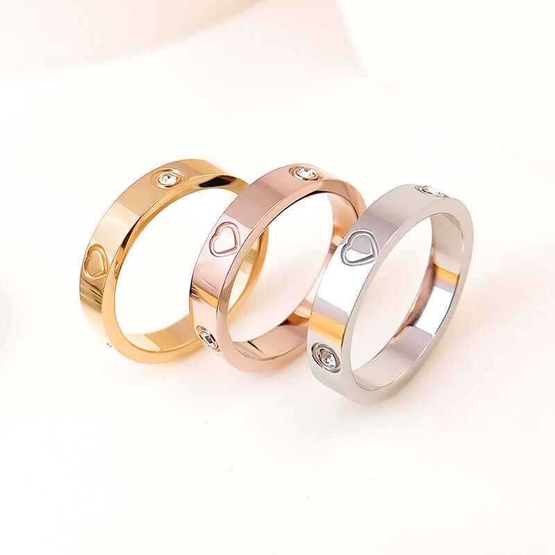 Rhinestone titanium steel bracelet ring set featuring gold, rose gold, and silver bands with heart designs.