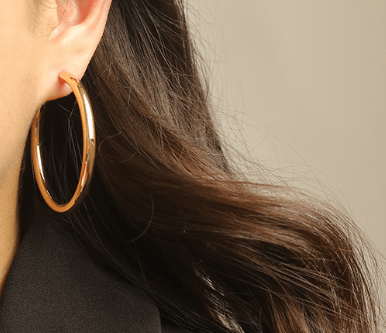 Minimalist brass hoop earrings showcased on a model, enhancing elegance and simplicity.