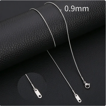 Minimalist stainless steel snake chain necklace displayed on black leather, showcasing its sleek design and 0.9mm thickness.