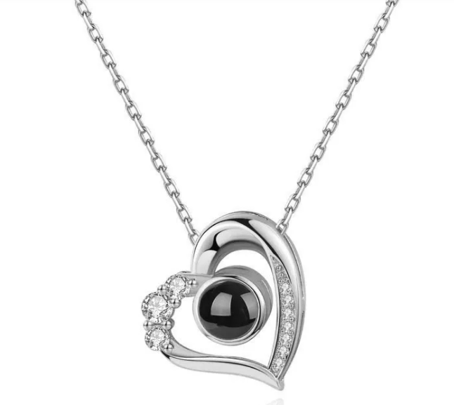 Silver geometric pendant necklace featuring a black center stone and sparkling accents in a heart design.
