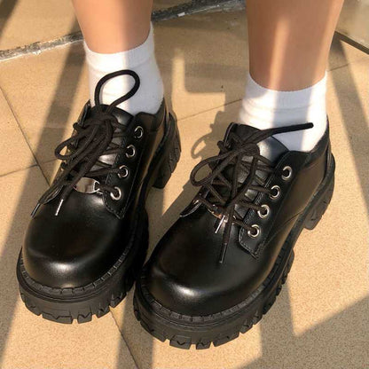 Thick soled leather shoes in black with round toe design, showcasing stylish comfort for summer outings.