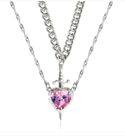Gold heart and sword necklace set featuring a pink diamond pendant on a stainless steel chain.