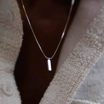 Stainless Steel Clavicle Chain Necklace featuring a minimalist design on a textured garment.