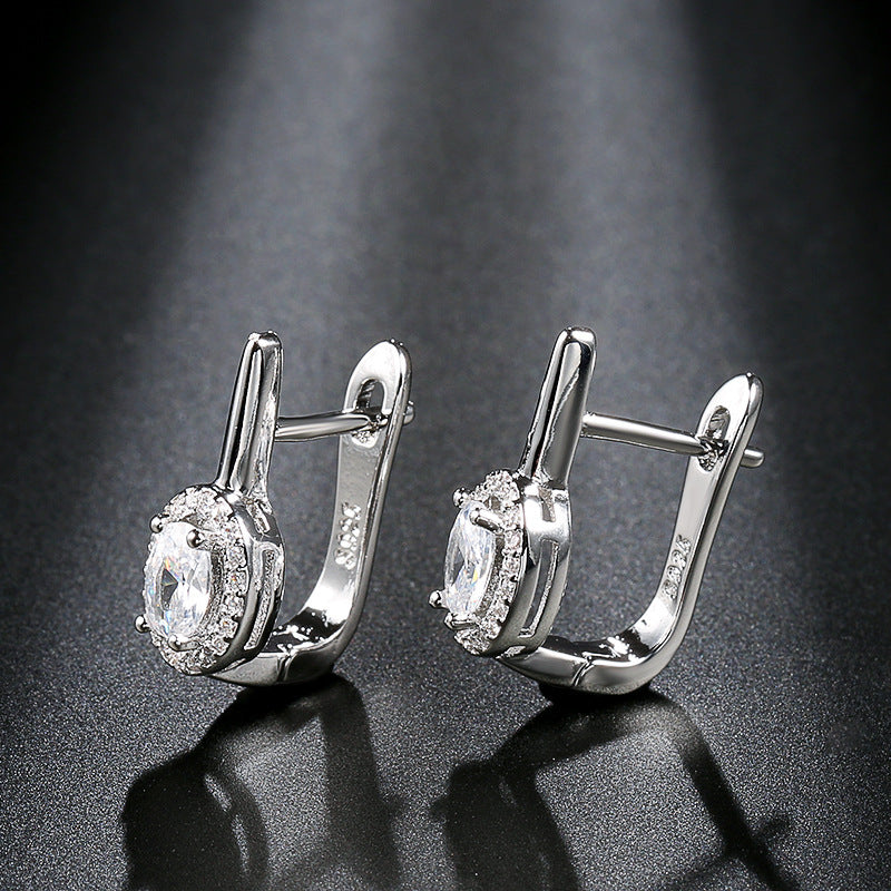 Zirconia circle stud earrings showcasing elegant design with sparkling rhinestones and shiny silver finish.
