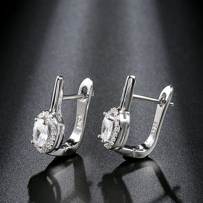 Zirconia circle stud earrings showcasing elegant design with sparkling rhinestones and shiny silver finish.